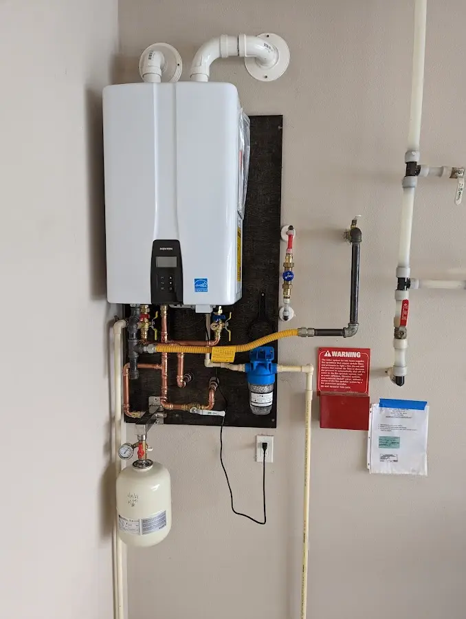 Professional plumber installing copper piping in a Commerce home